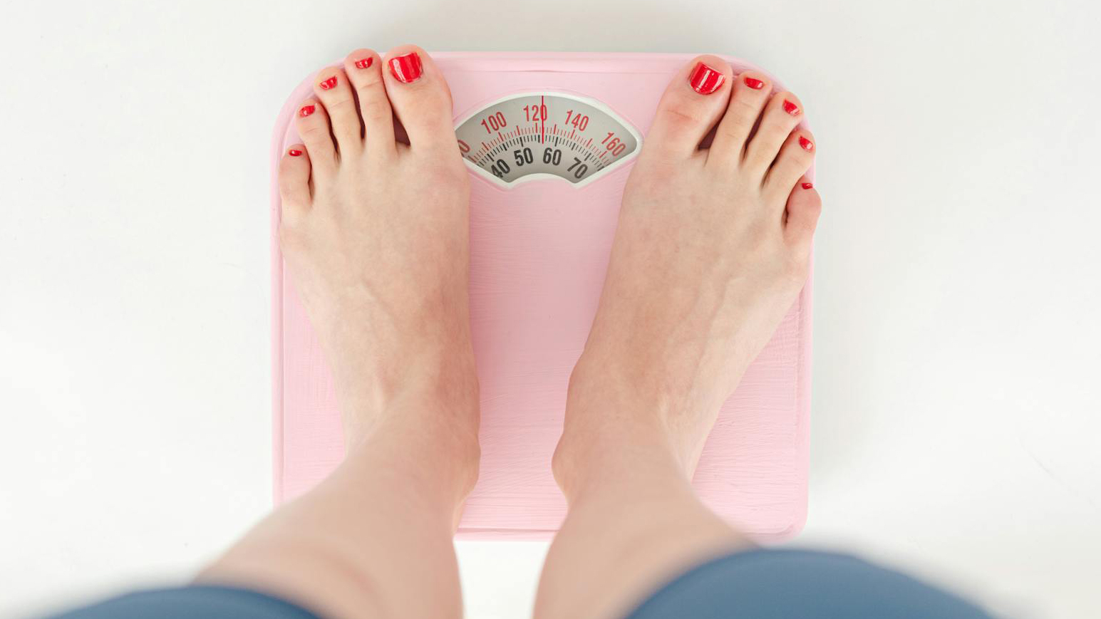 girl standing on pink scale