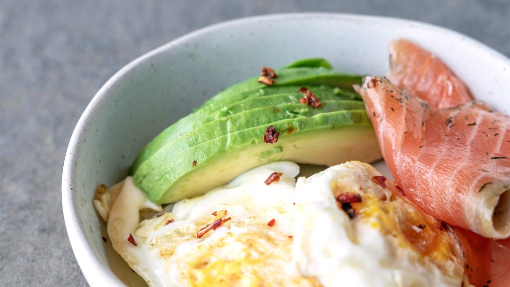 Salmon, avocado, and fried egg in a bowl