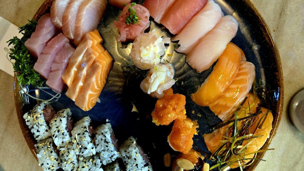 plate of sushi and seafood high in protein